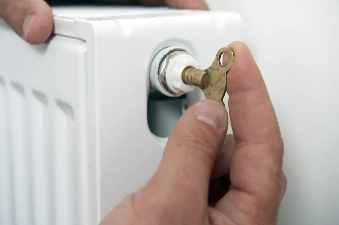 Bleeding a radiator during a boiler repair visit